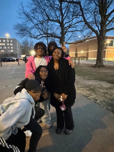 A group of 5 students posing together