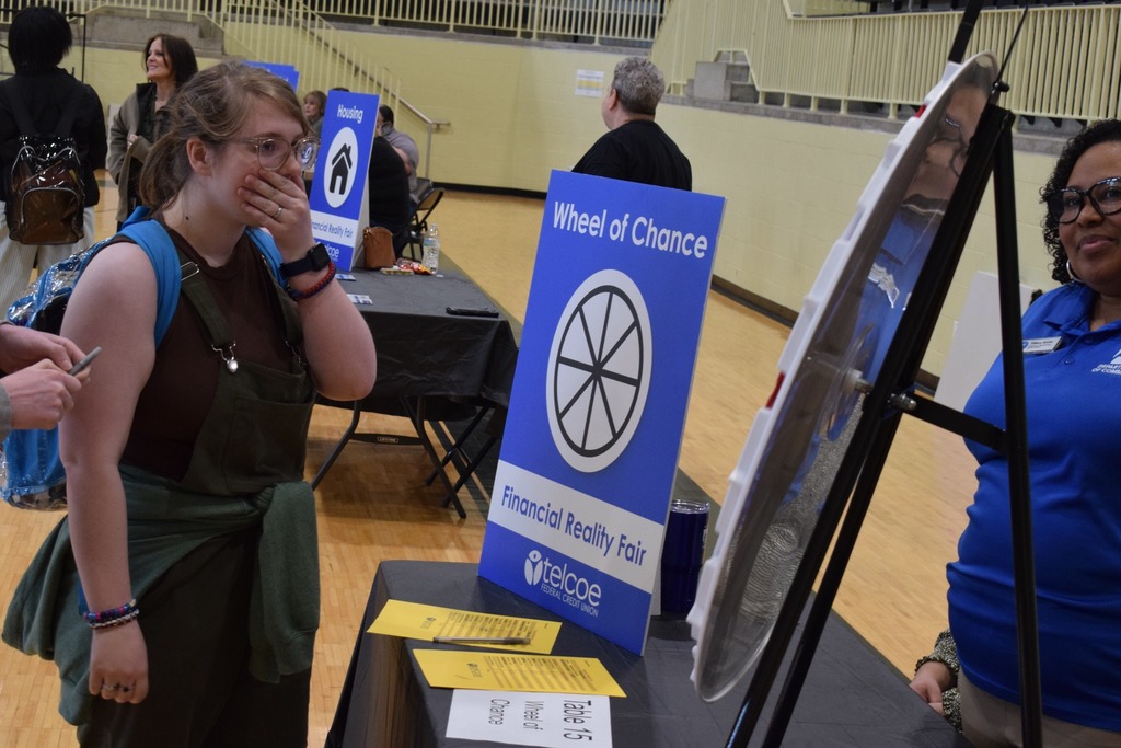 A student gasping at her roll on the wheel of chance