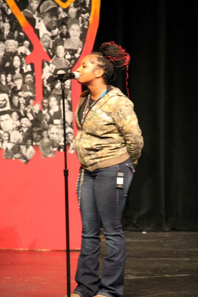 A girl speaking at a microphone
