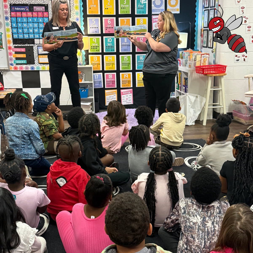 Crystal Hill Elementary students listening to a book being read to them.