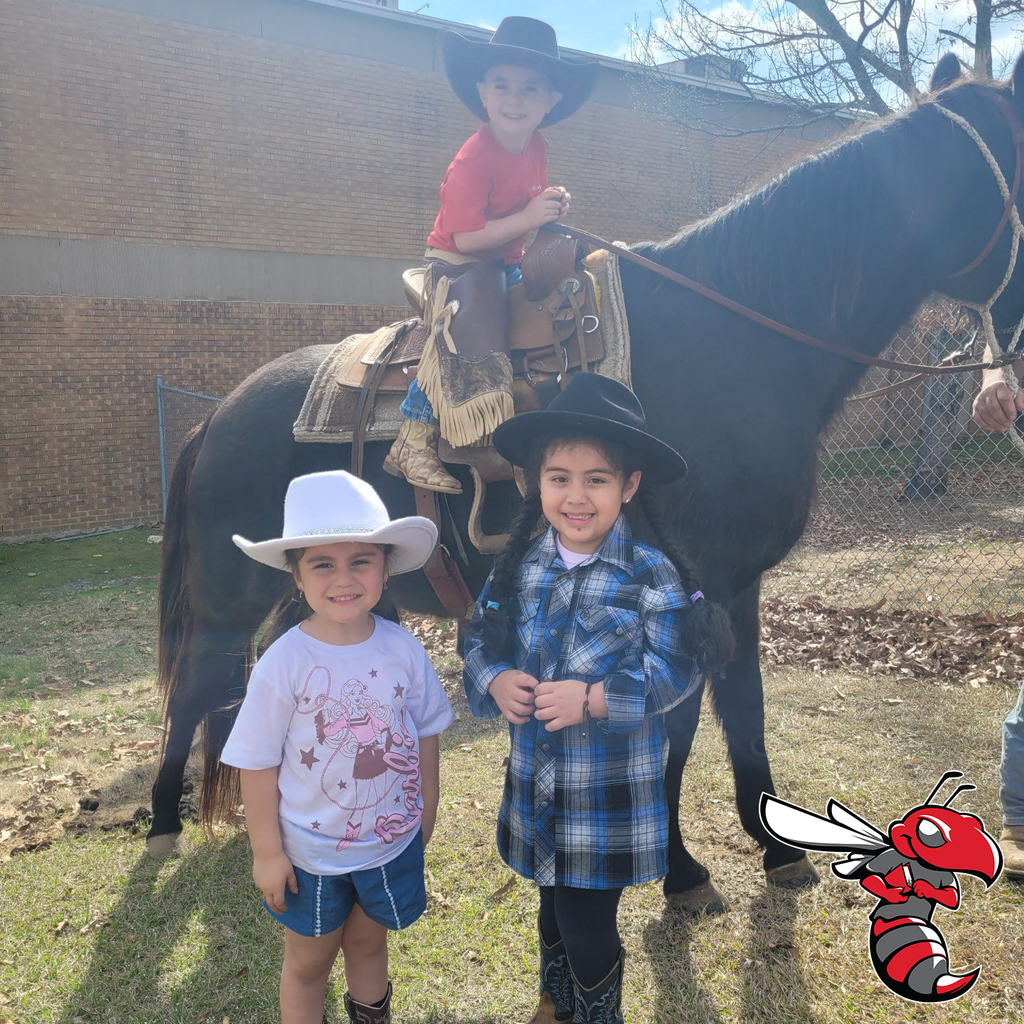 Students from Oak Grove Elementary dressed as cowboys. One is riding a horse.