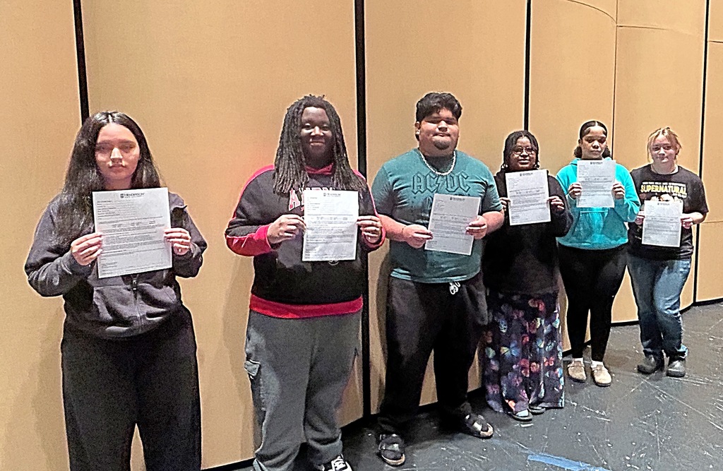 Six students holding certificates