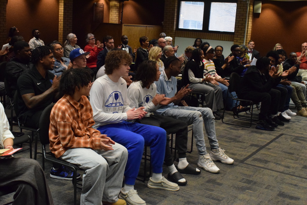 Sylvan Hills Jr. High Basketball team at the PCSSD board meeting sitting down.