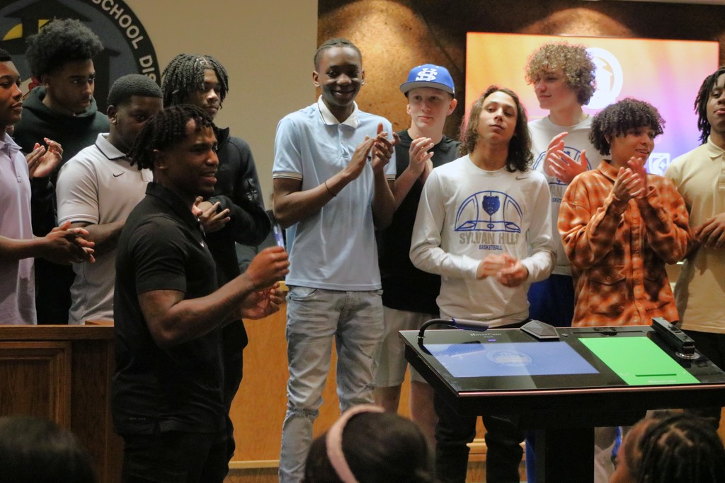 Sylvan Hills Jr. High Basketball team clapping at the PCSSD board meeting