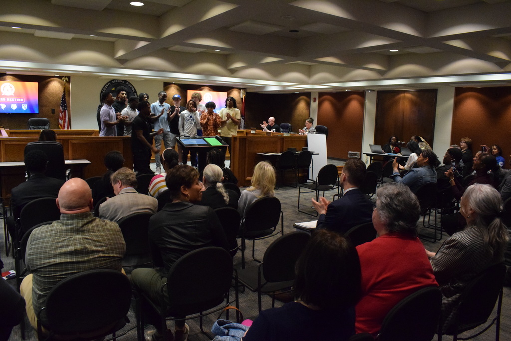 Sylvan Hills Jr. High Basketball team at the PCSSD board meeting in a wide shot that shows the whole room.