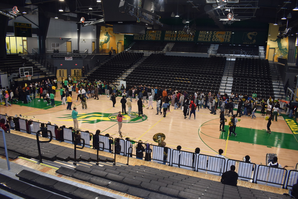 A full court of students. Some are holding instruments, others are holding pom poms.