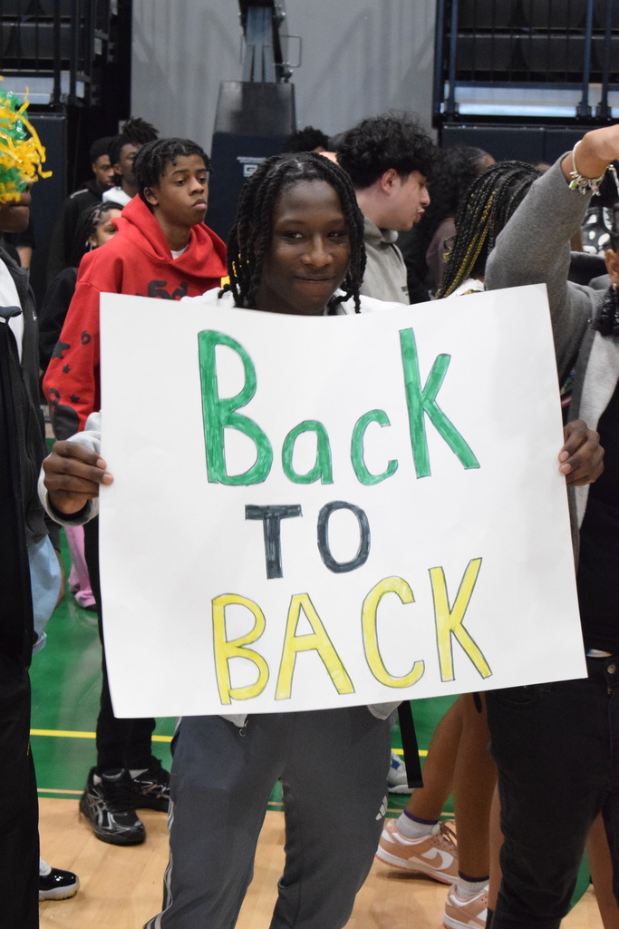 A student holds a "back to back" sign