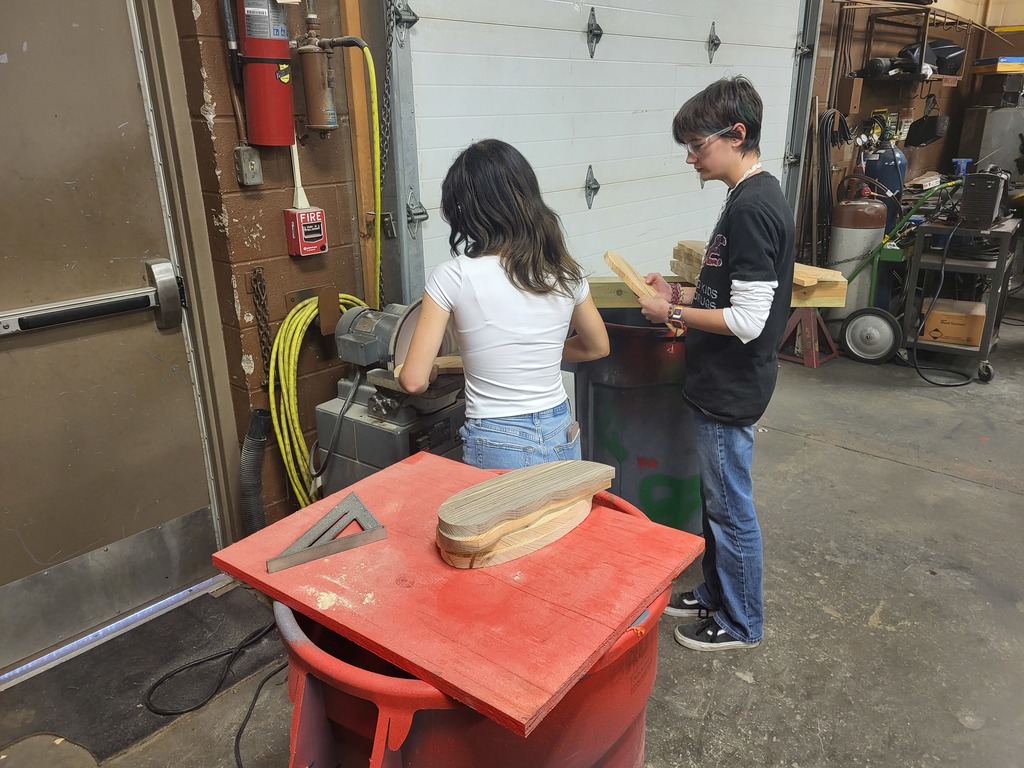 RHS students in shop class, sanding  various pieces of the birdhouses to be assembled. 