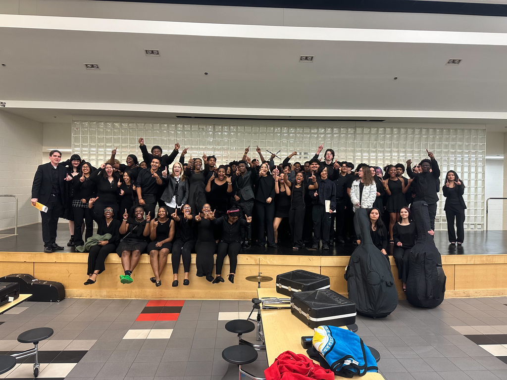 The MUSHS band celebrating 2026 Assessment at the Maumelle High cafeteria stage