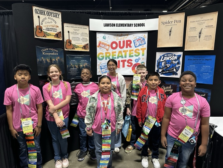 image of EAST conference team in front of their display. 