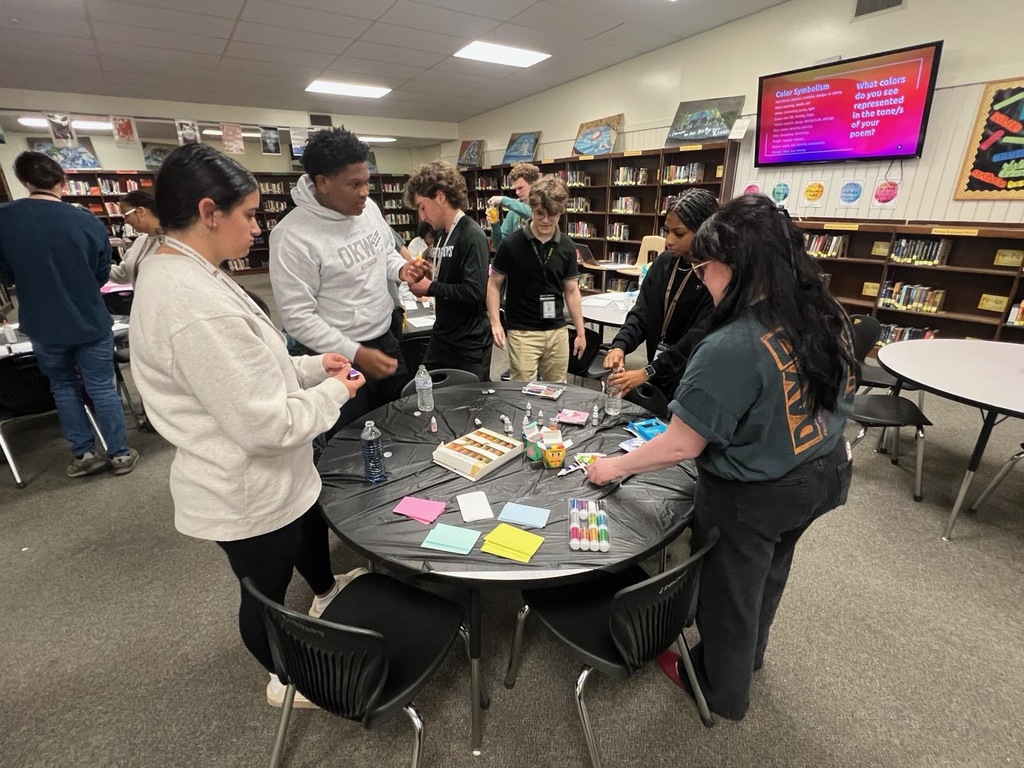 RHS students work together with their Ms. Hittle to create a visual to reflect the tone of a poem. 
