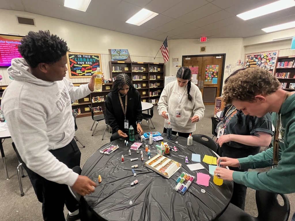 AP Lit.  Poetry March Madness Bracket  - students adding food coloring and glitter to water bottles to match the tone of the poem. 