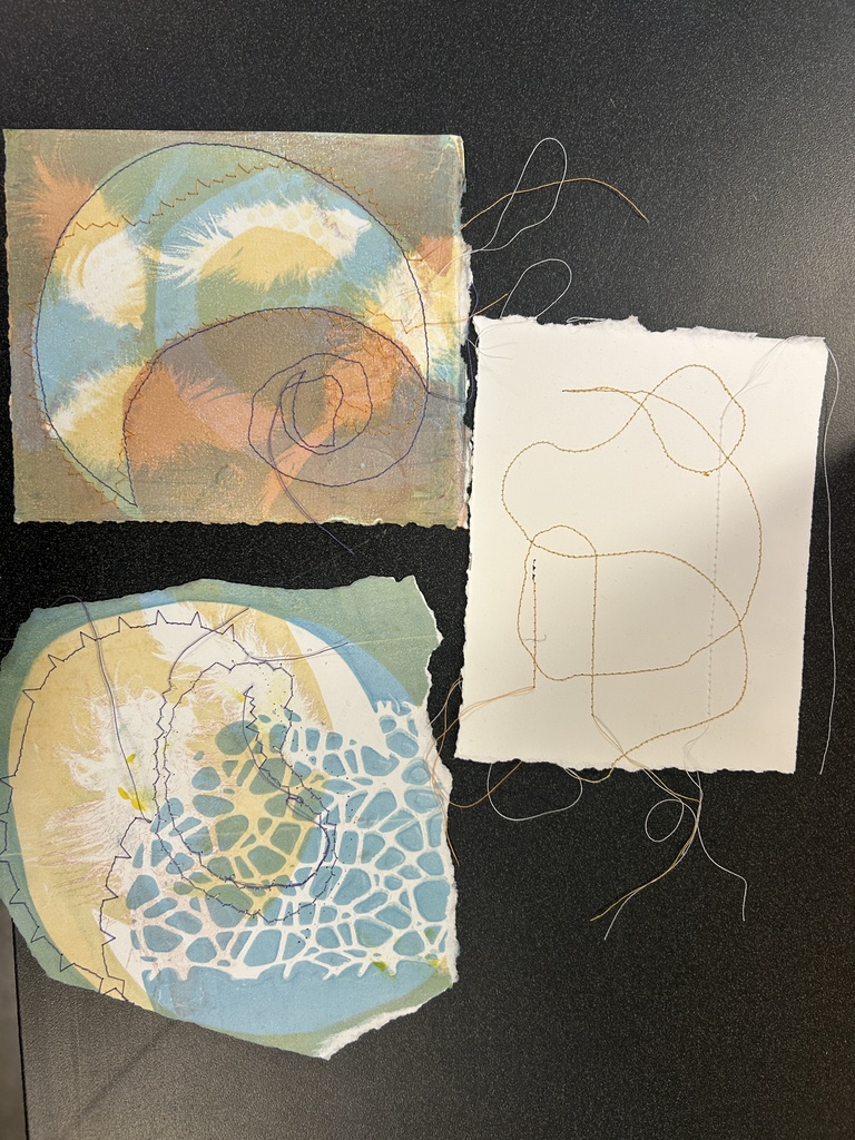 Images of thread sewn on color paper