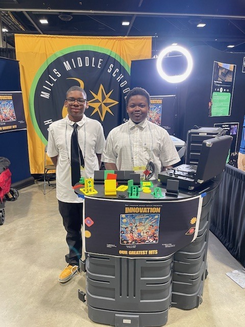 picture of Dwight Brown and Marcus Humphrey in front of their phone stand entry at the EAST Conference