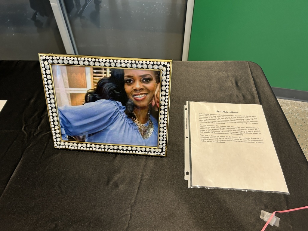 Photo in a frame beside paragraphs on paper