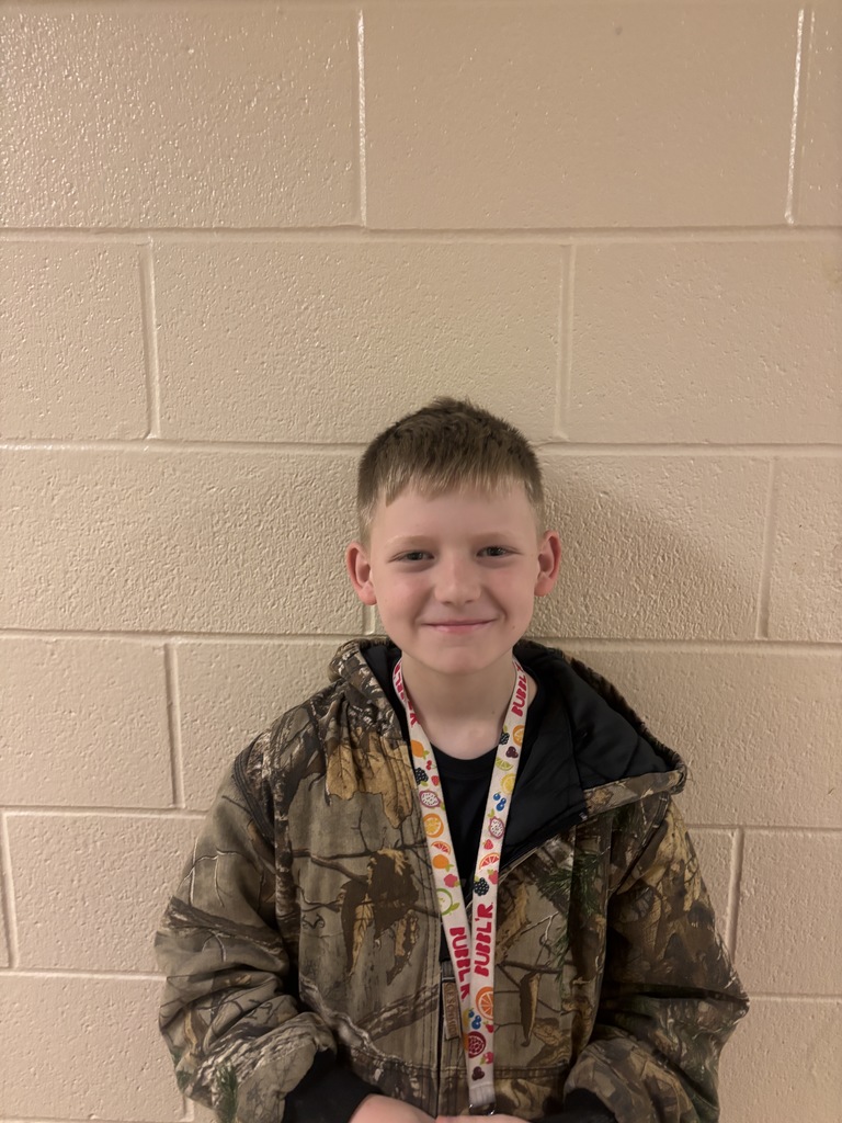 Image of fifth grade student who was nominated for student of the month. He is wearing a black shirt and camo jacket. 
