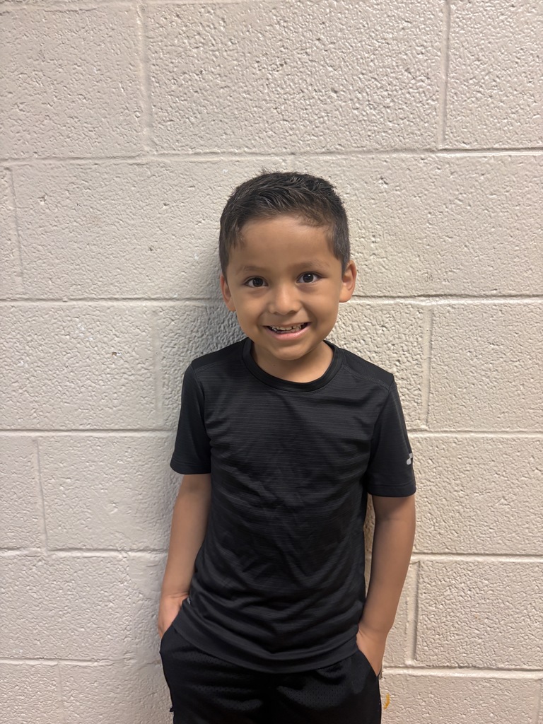 Image of Kindergarten Student who was nominated for Student of the Month. He is wearing a black t shirt. 