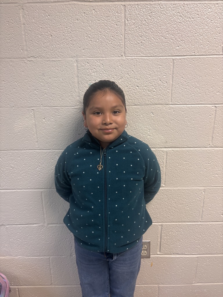 Image of Fourth Grade student who was nominated for student of the month. She is wearing a blue jacket with white dots. 