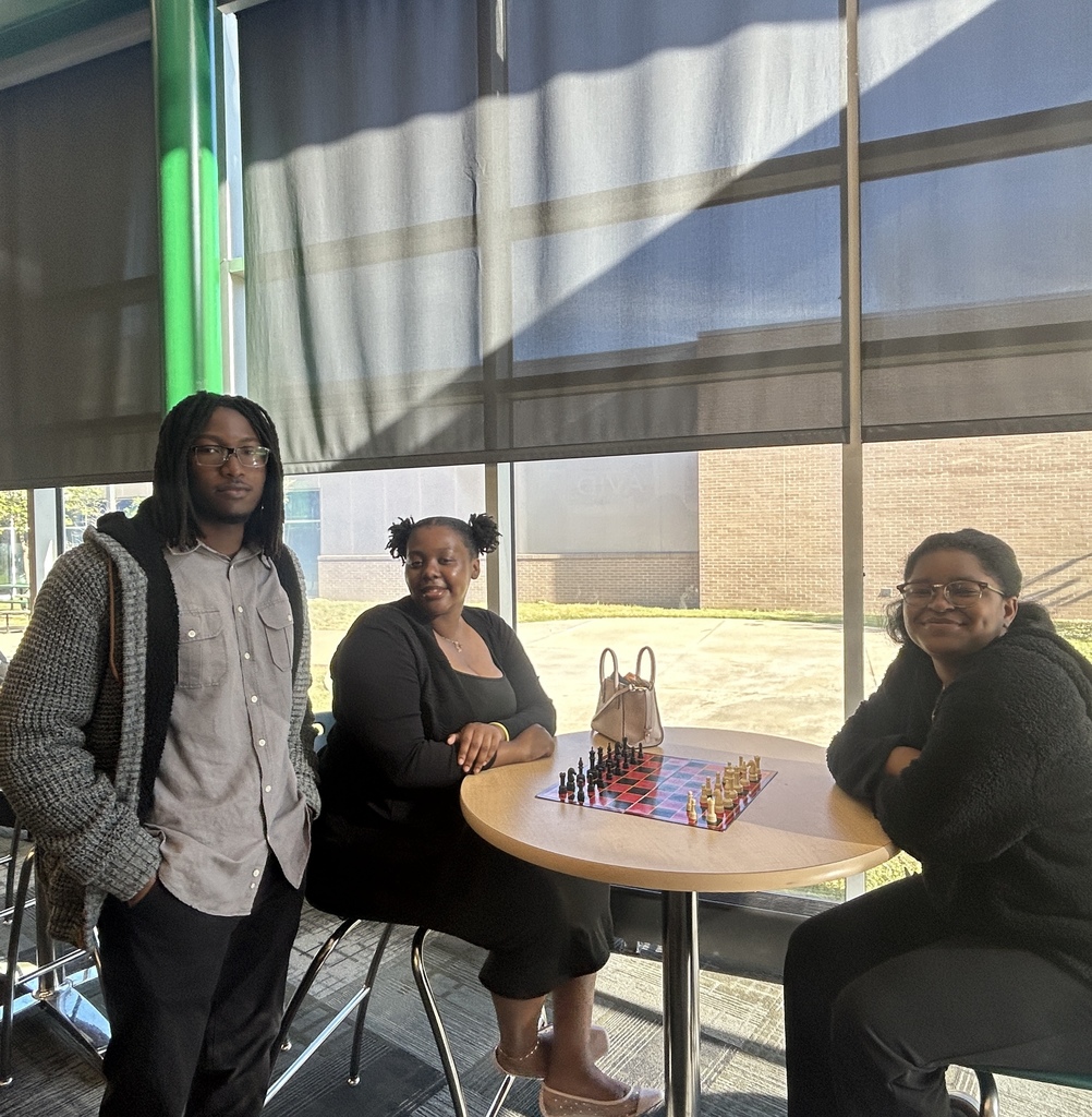Three students smiling for the camera