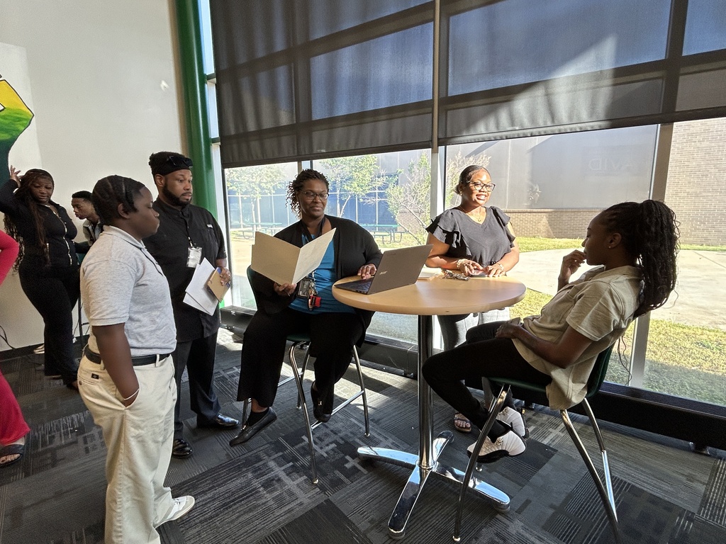 Teachers and students seated around a table