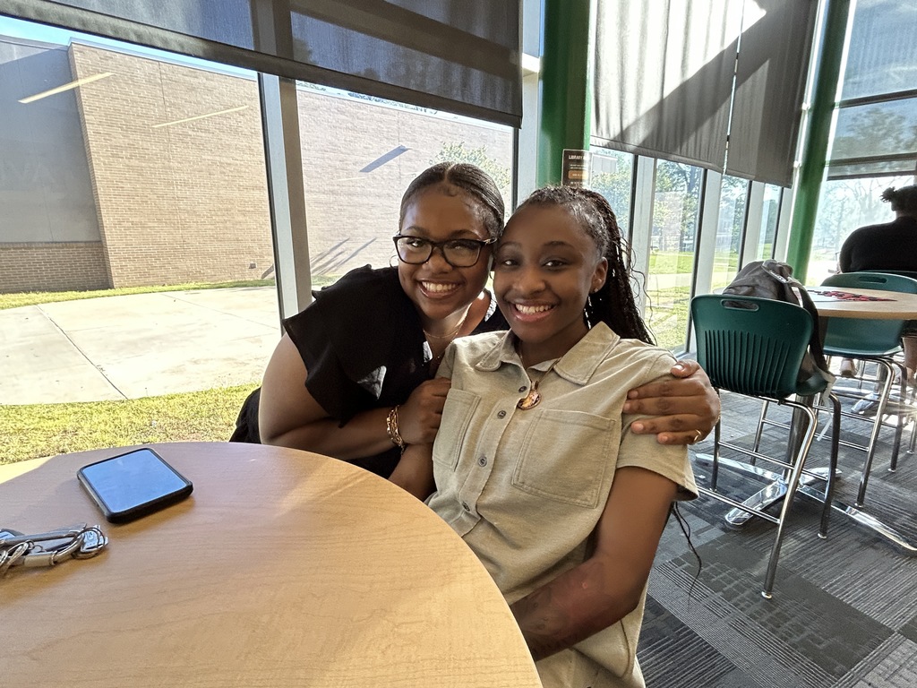 Two students hugging for the camera