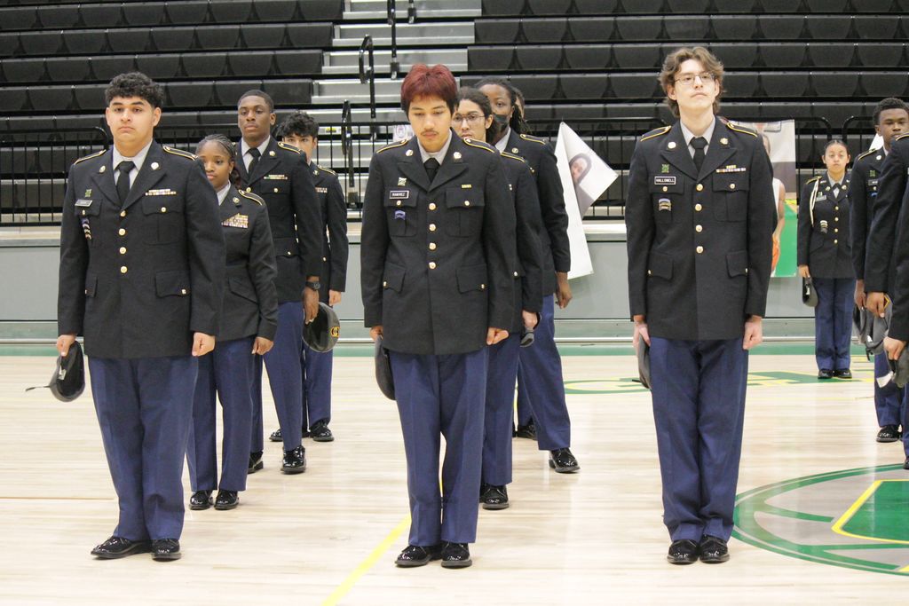 Mills University Studies High School JROTC cadets holding their caps and standing proudly at attention in their dark blue uniforms during their 2026 JPA inspection.