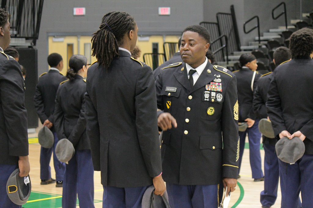 A Master Sergeant instructor speaking with Mills High School JROTC cadets during their formal accreditation inspection in Cooper Arena.
