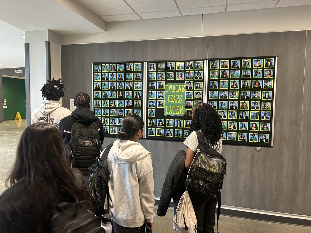 Students looking at senior portraits on a bulletin board