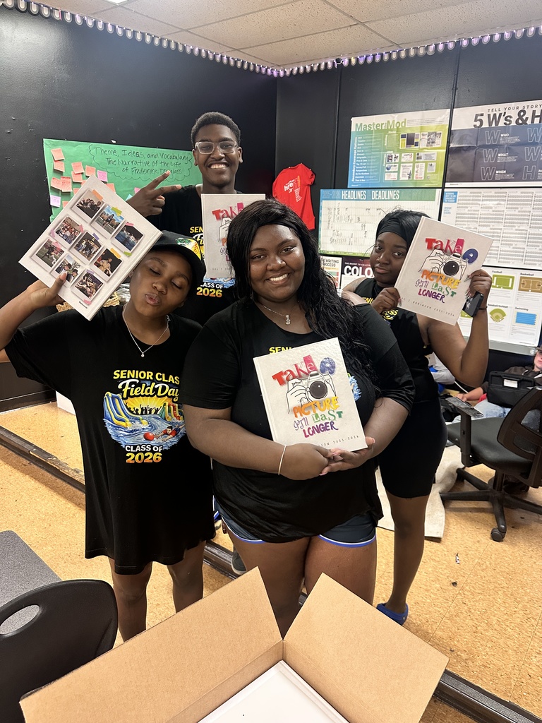 RHS Seniors showing off their handiwork! The 2025-2026 yearbooks are in!