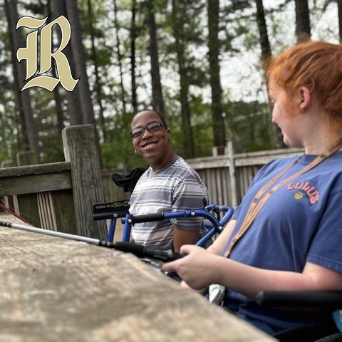 Happy students fishing in a forest setting. Joe T. Robinson High School logo is present.