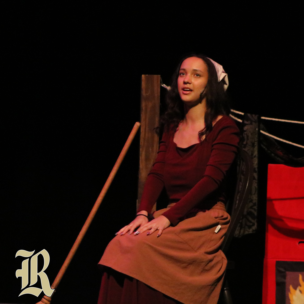 An actress on stage performing Cinderella