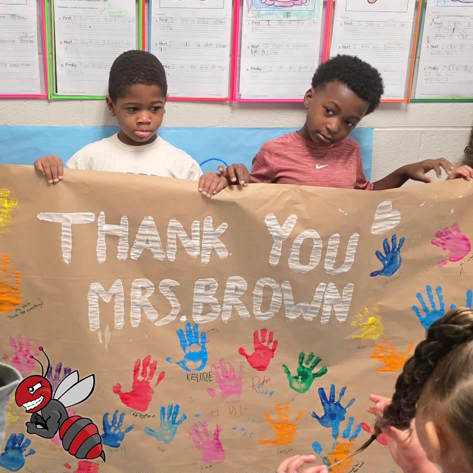 Students holding a sign that says Thank you Mrs. Brown.