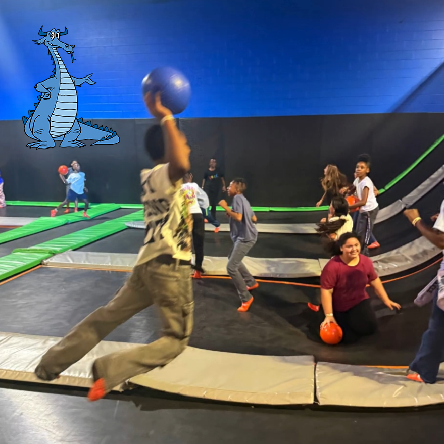 Students playing dodgeball on an indoor trampoline court.