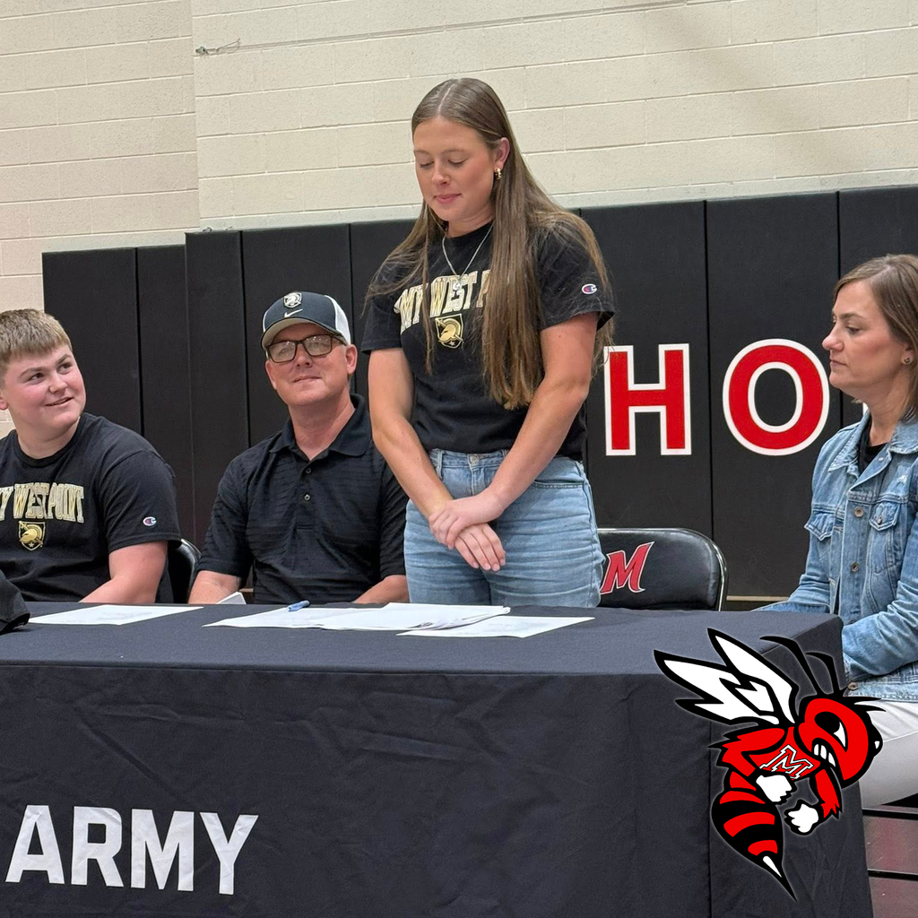 A student stands at a table with Army West Point branding.