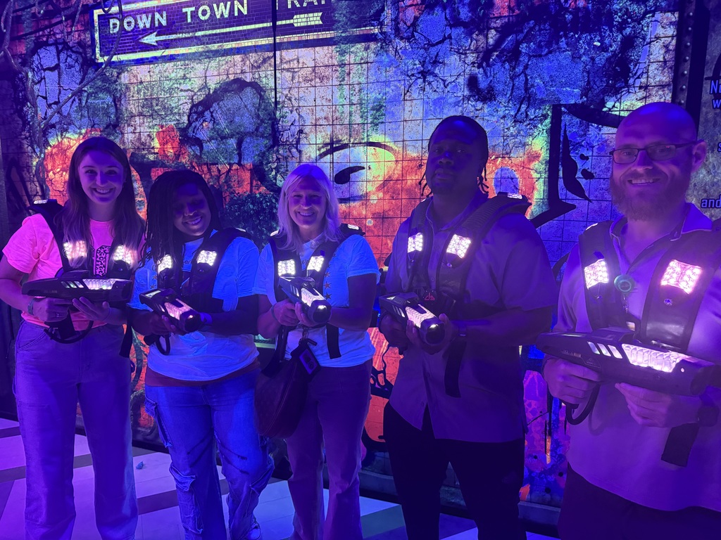 Teachers in laser tag outfits