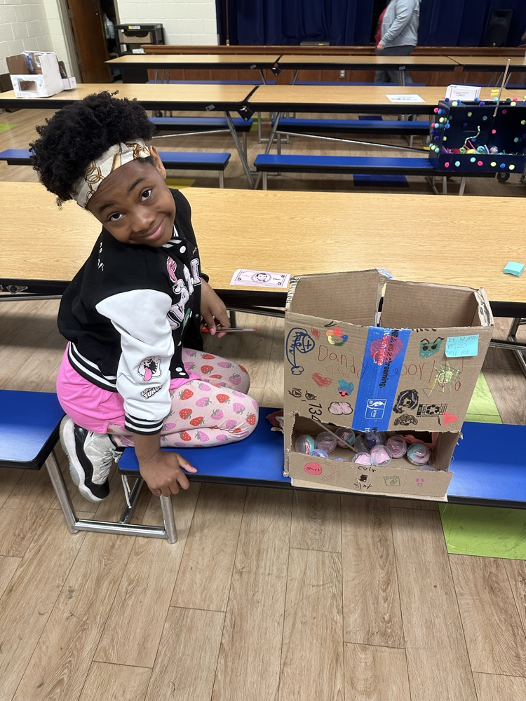 4th grade student with a claw machine