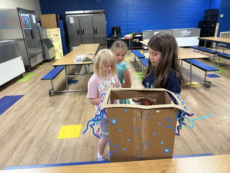 kindergartners trying out one of the claw machines
