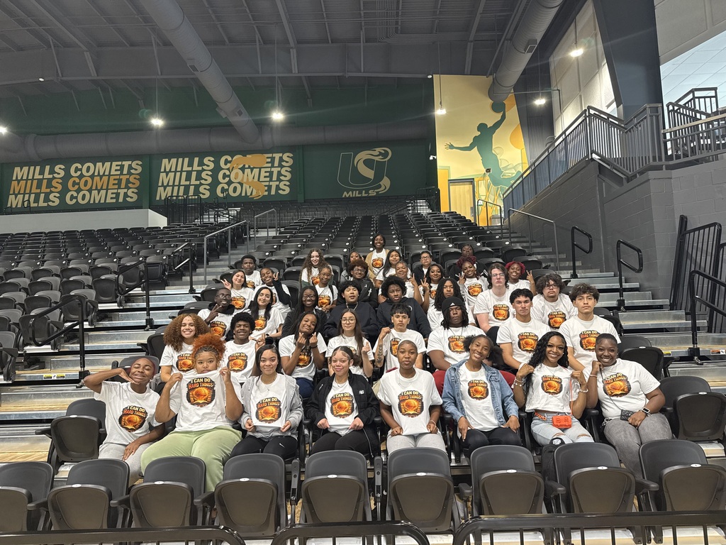 Large group of students in stadium seating wearing matching tshirts
