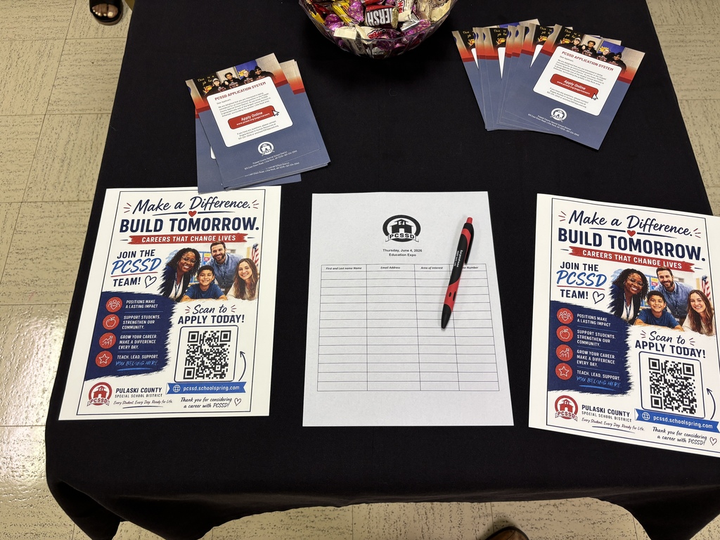 A table with flyers and a sign up sheet