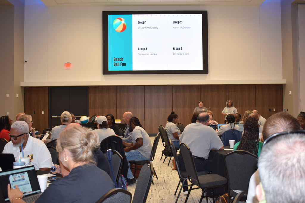 Large room with people at round tables