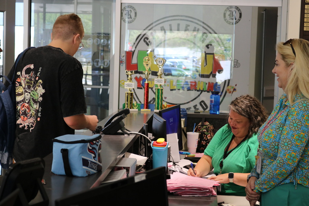 a student signing in at a front desk