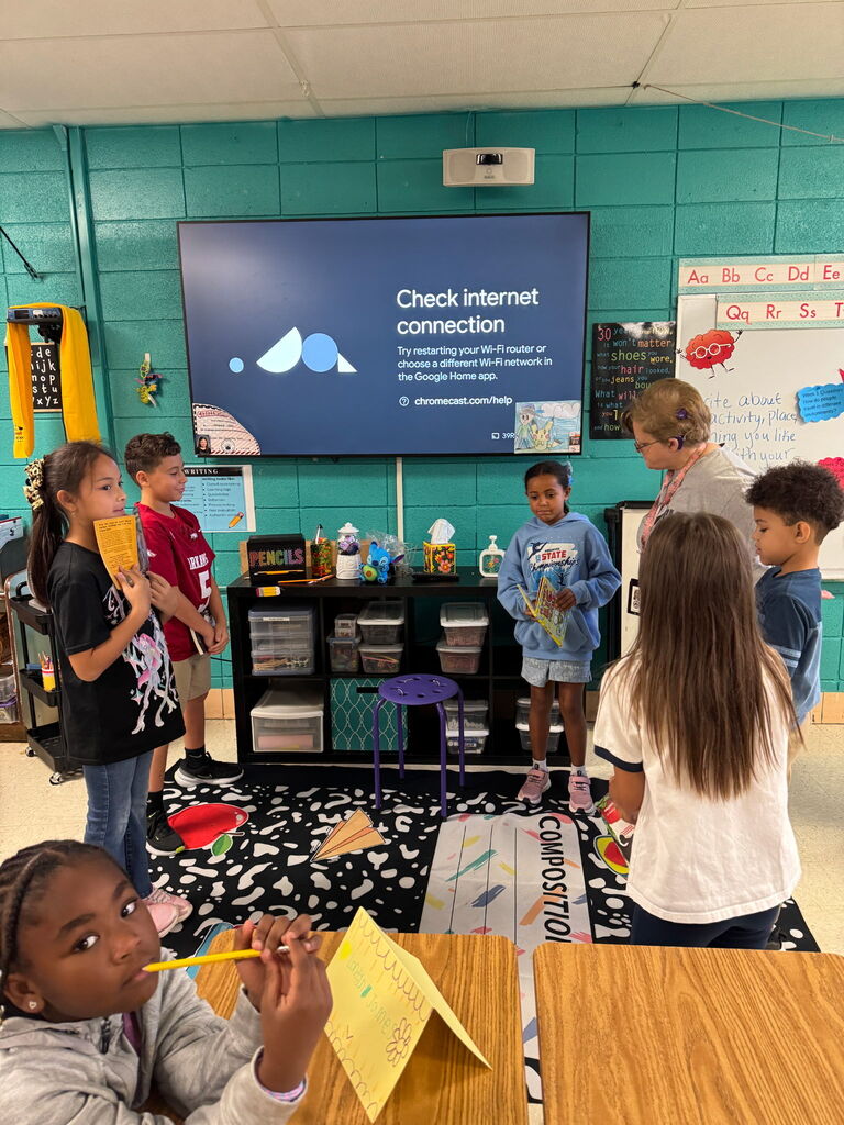 Students and a teacher standing around working on communication skills