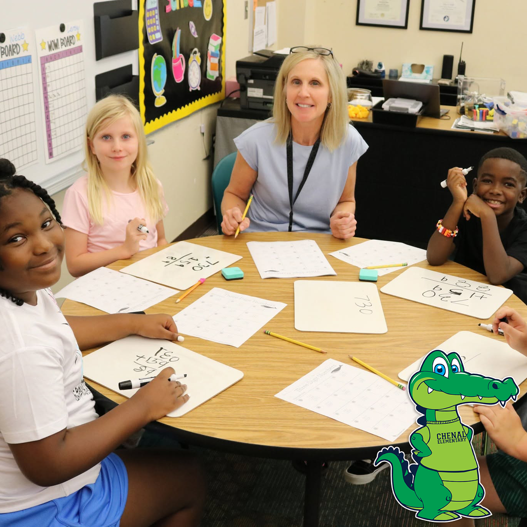 A teacher at a table with smiling children