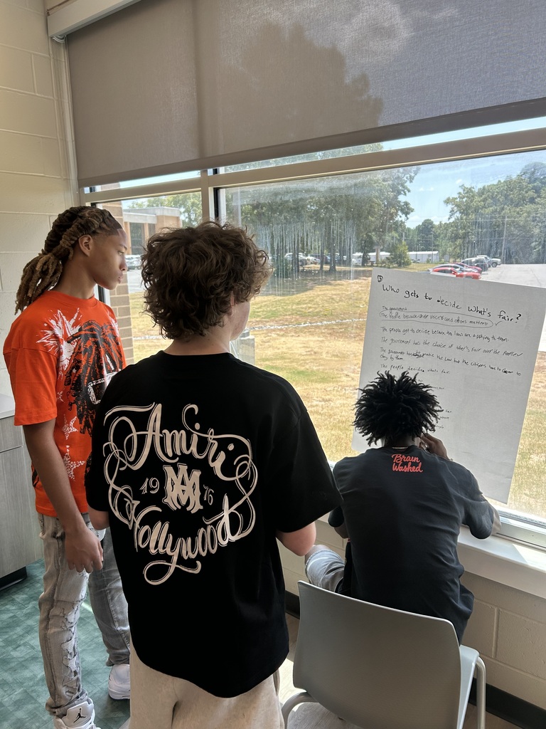 Students making a list on chart paper