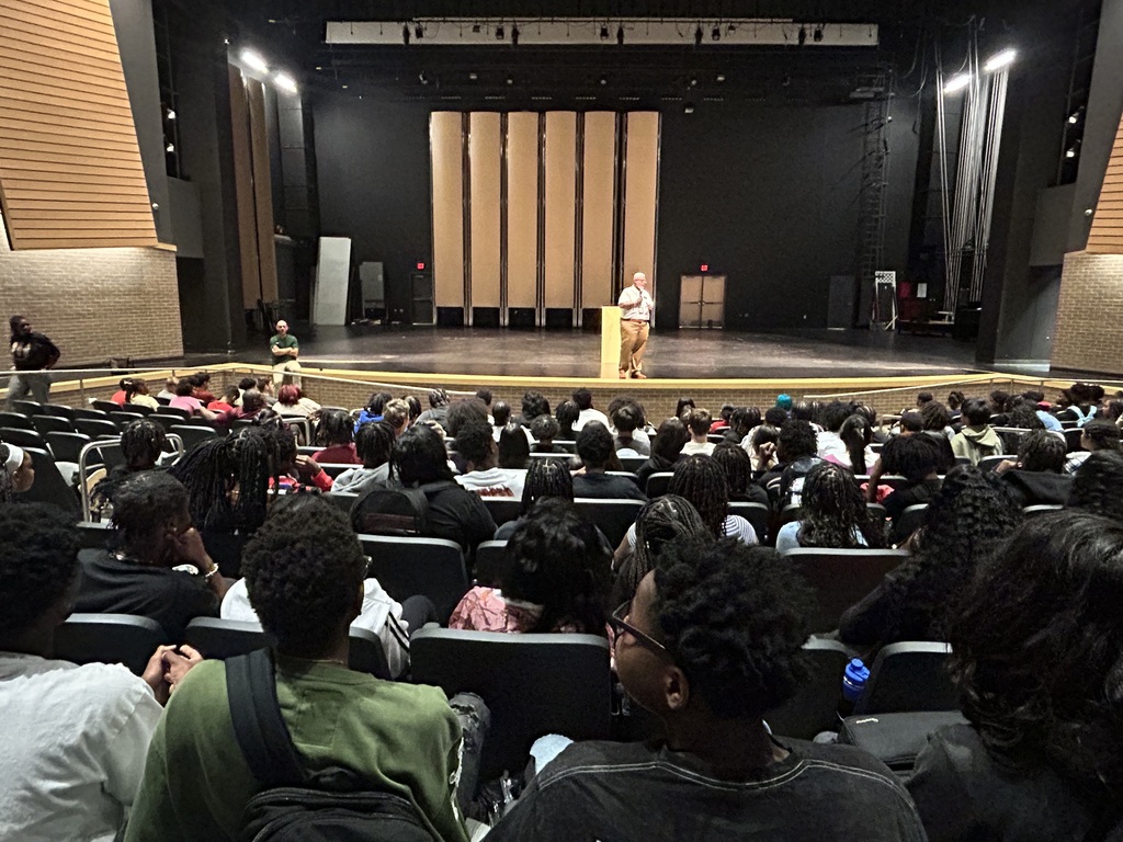 Students in the auditorium listening to speaker