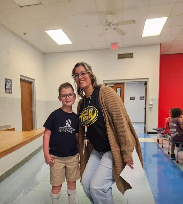 Two people wearing college shirts