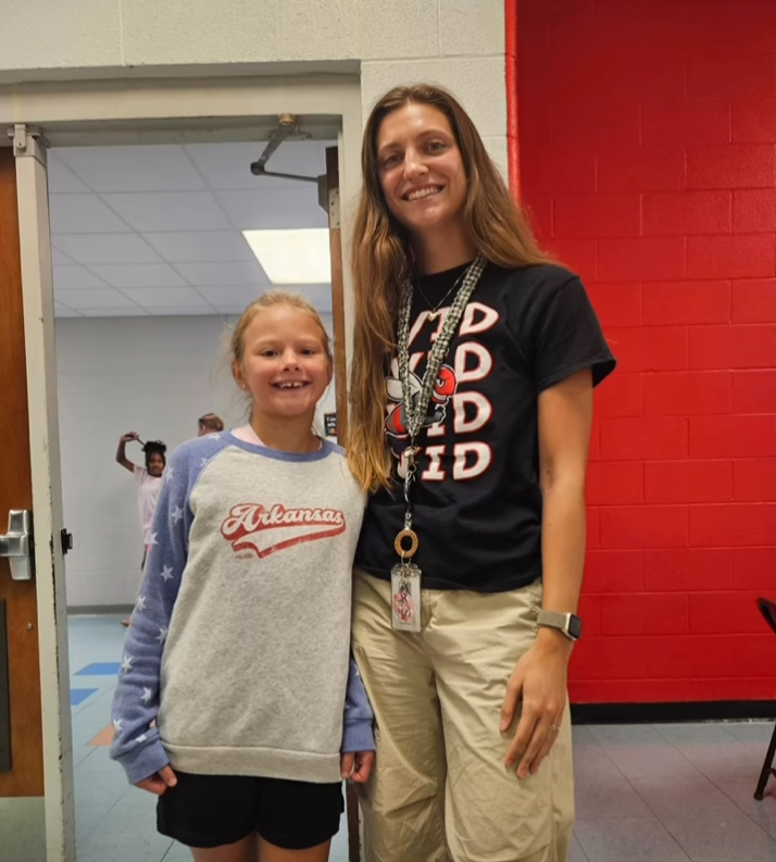 Two people wearing AVID shirts
