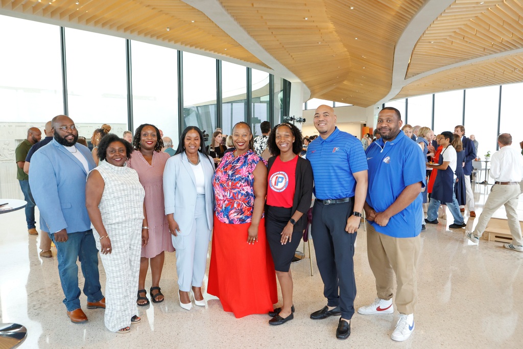 A group photo of officials representing three schools within the Arkansas Museum of Fine Arts