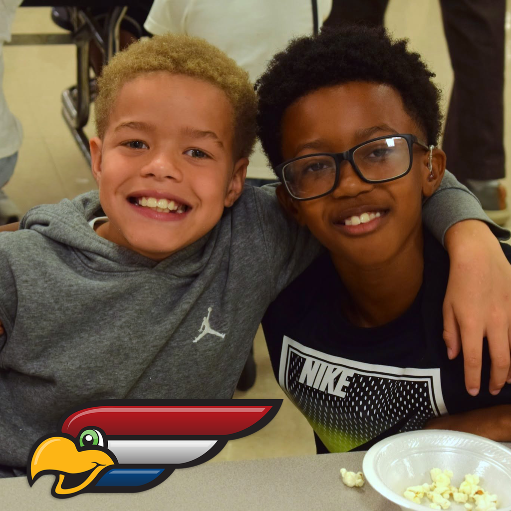 Two student smiling with their arms over each other