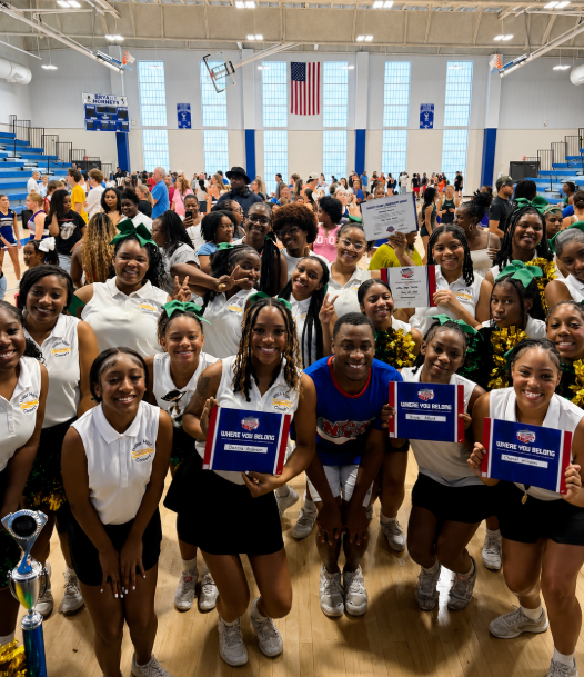 Image of cheerleaders holding awards